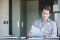 Man reading document in office — Stock Photo