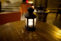 Close up of Illuminated lantern on table — Stock Photo