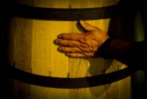 Close up of Hand touching wooden cask — Stock Photo