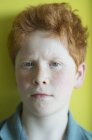 Portrait of Boy with red hair furrowing brows — Stock Photo