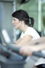 Woman working out in fitness club — Stock Photo