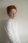 Portrait of Boy with red hair against grey background — Stock Photo