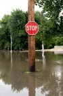 Stop sign on flooded street — Stock Photo