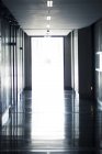 Open doors at end of empty hallway — Stock Photo