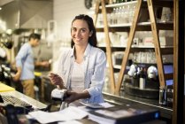 Женщина, использующая считыватель кредитных карт в ресторане — стоковое фото