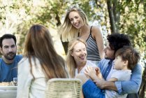 Friends and family enjoying meal together outdoors — Stock Photo