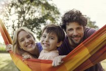 Portrait  of family relaxing with hammock outdoors — Stock Photo