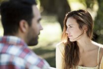 Back view of man with thinking woman outdoors — Stock Photo