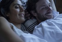 Couple watching tv together in bed — Stock Photo