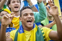 Brazilian football fans cheering at match — Stock Photo