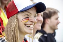 German football fan smiling at match — Stock Photo