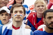 French football fans watching match attentively — Stock Photo