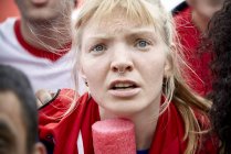 Woman watching football match with furrowed brow — Stock Photo