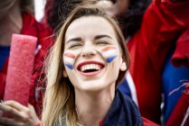 French football fan smiling at match, portrait — Stock Photo