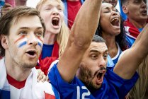 French football fans watching football match — Stock Photo