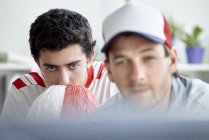 Sports fans anxiously watching match on TV — Stock Photo