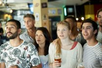 Soccer fans watching match together at pub — Stock Photo