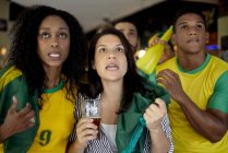 Brazilian football supporters watching match in bar — Stock Photo