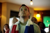 French football fan watching match in bar — Stock Photo