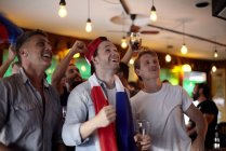 French football fans watching match in bar — Stock Photo