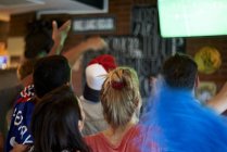 French football fans watching soccer match on television at pub — Stock Photo