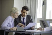 Man and woman reviewing document — Stock Photo
