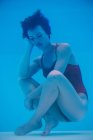Woman soaking underwater with sad expression — Stock Photo