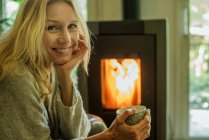 Зріла жінка розслабляється з кавою вдома, портрет — стокове фото