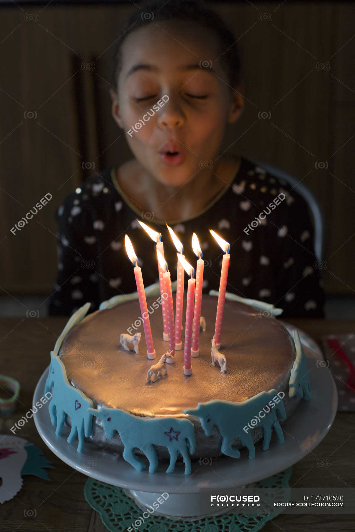 Girl blowing out candles on birthday cake — food, birthday party Stock Photo 172710520