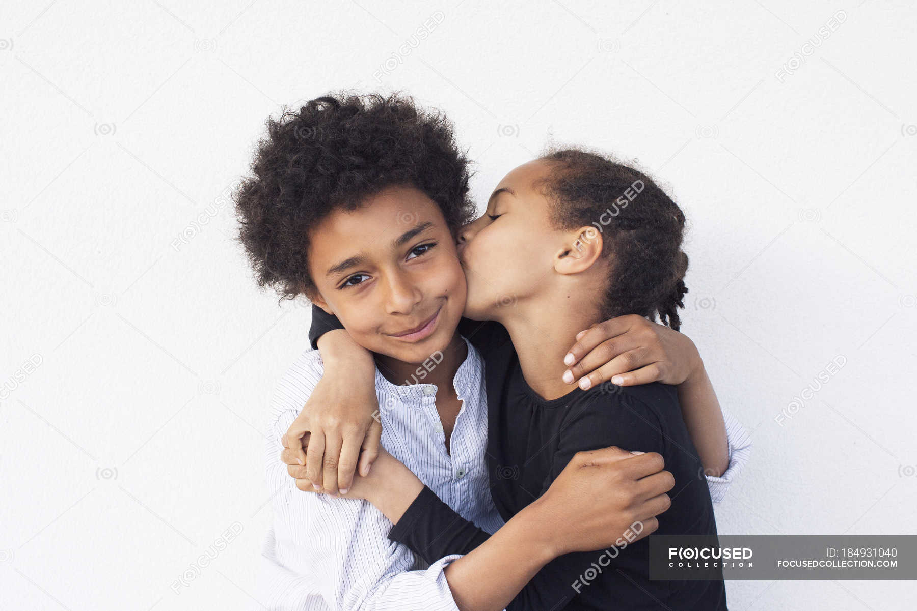 Portrait of Brother and sister embracing against white background — people,  side by side - Stock Photo | #184931040