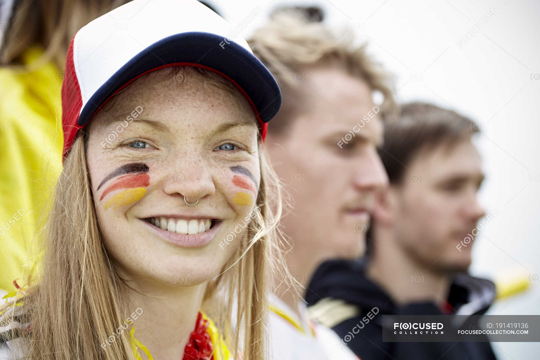 german-football-supporter-smiling-at-match-view-fans-stock-photo