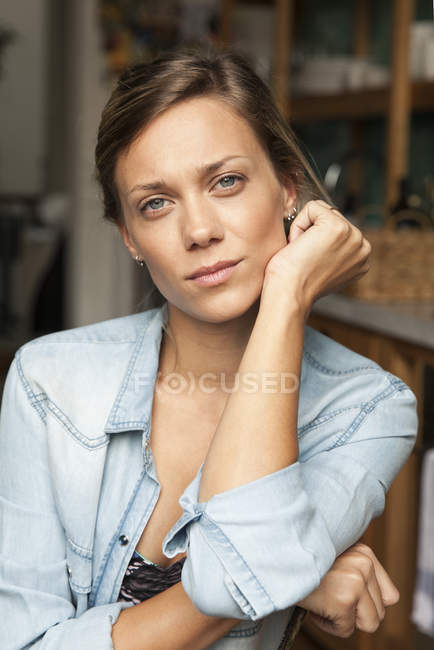 Portrait of serious woman sitting on the chair — Stock Photo
