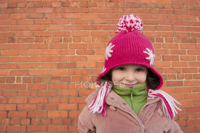 Little girl wearing knit hat outdoors, portrait — Stock Photo