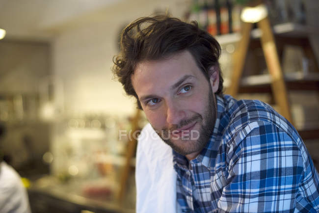 Portrait of waiter with towel on the kitchen — Stock Photo