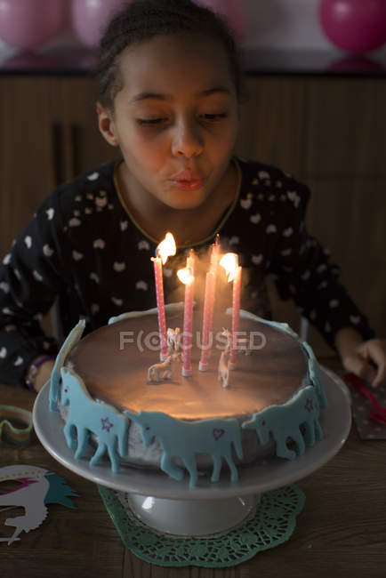 Ragazza che spegne candele sulla torta di compleanno — Foto stock