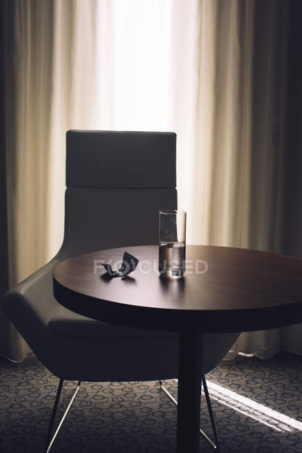 Glass of water and medication on table — Stock Photo
