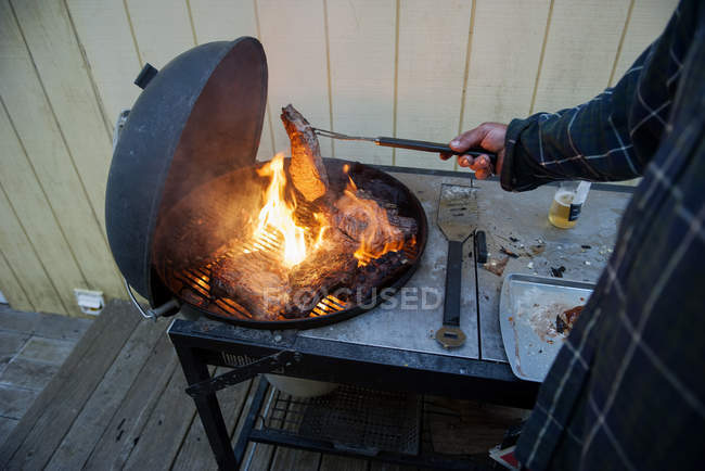 Close up of man Grilling steaks — Stock Photo
