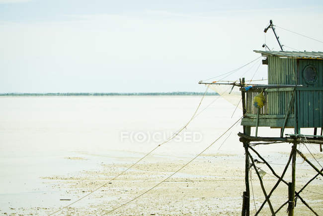 Cabane de pêche sur pilotis près du bord de l'eau — Photo de stock