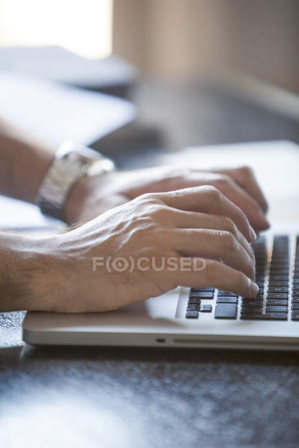 Hands typing on laptop computer keyboard — Stock Photo