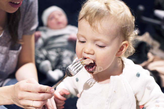Close up of Mother feeding toddler — Stock Photo