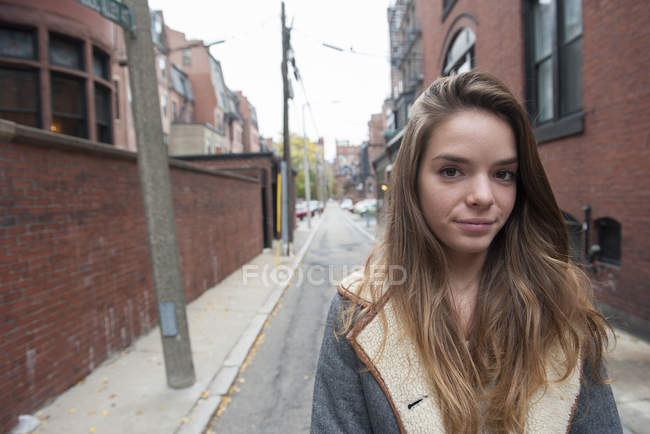 Portrait of teenage girl standing in alley — Stock Photo