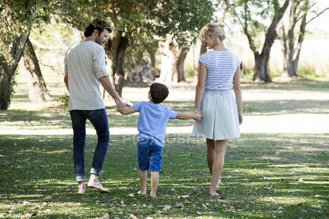 Family with one child relaxing together outdoors picnic — Stock Photo