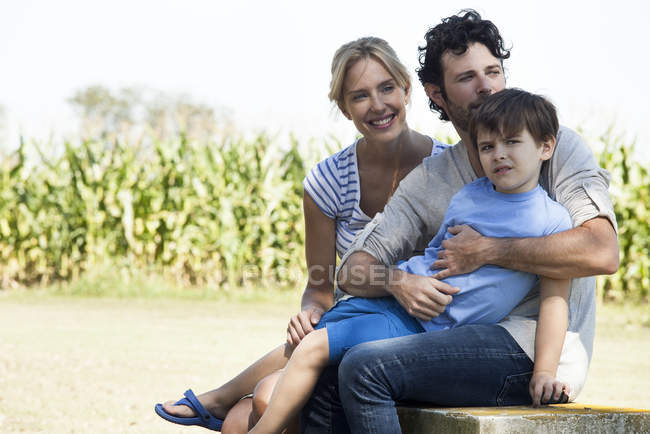 Family with one child relaxing together outdoors picnic — Stock Photo