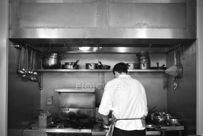 Back view of Restaurant chef cooking at stove — Stock Photo