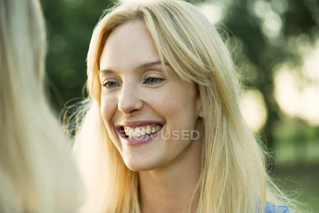Portrait of smiling blonde woman outdoors — Stock Photo