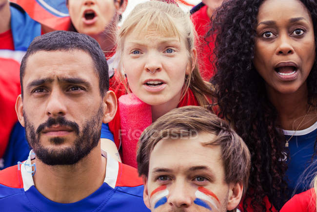French football fans anxiously watching match — Stock Photo
