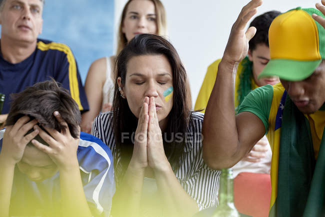 Upset Brazilian football fans while watching match at home — Stock Photo