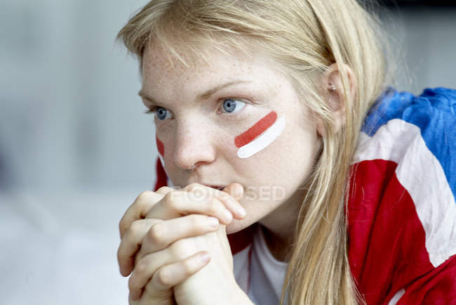 Closeup portrait of English soccer fan with hands on chin — Stock Photo