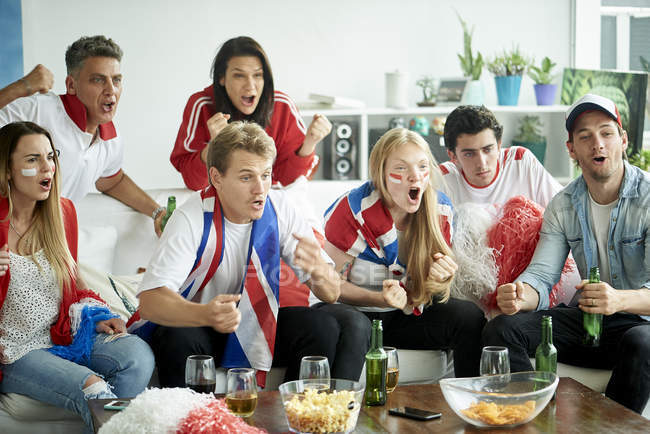 English soccer fans watching match together at home — Stock Photo