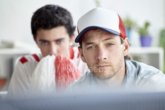 Two sports fans watching match on TV — Stock Photo